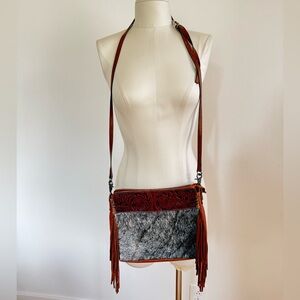 hand-tooled genuine leather and hair-on cowhide fringe crossbody bag
